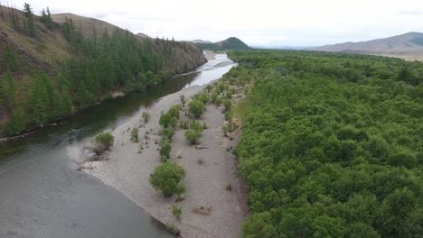 Aerial-drone-shot-following-a-river-in-Mongolia-.-Cloudy-day